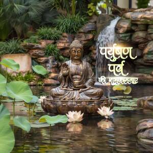 Buddha statue in a peaceful garden with a waterfall and lotus flowers