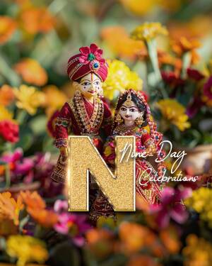 Traditional Indian dolls dressed as a bride and groom with a golden 'N' for Navratri
