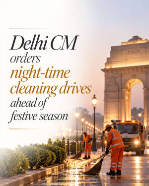 Municipal workers cleaning streets near India Gate in Delhi at night