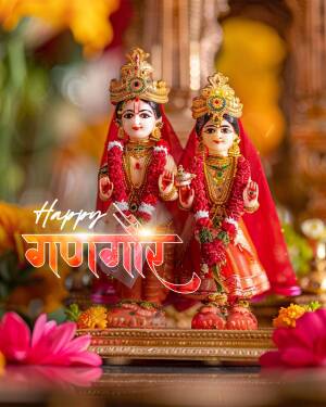 Two idols of Hindu deities adorned with flowers and traditional attire for the Gangaur festival.