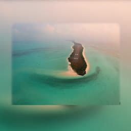 Aerial drone photography of the landing strip at Agatti Island Airport surrounded by turquoise coral reef waters