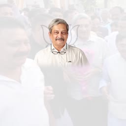 Portrait of former Indian Defence Minister Manohar Parrikar with a faded crowd background