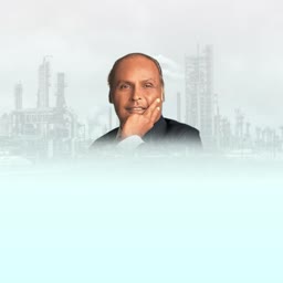 Mukesh Ambani positioned in front of an industrial plant background