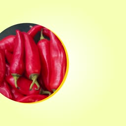 A cluster of fresh, vibrant red chili peppers arranged in a circle against a light yellow background.