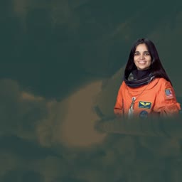 Portrait of astronaut Kalpana Chawla in an orange space suit against a dark background