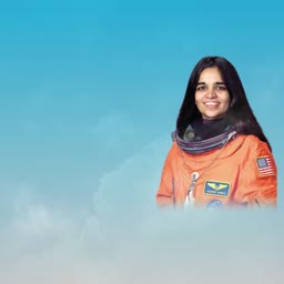Kalpana Chawla wearing her orange NASA flight suit against a blue sky background
