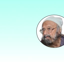 An elderly man with a beard and a beanie wearing glasses, set against a light blue background.