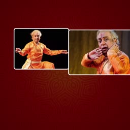 Pandit Birju Maharaj performing Kathak dance in traditional orange attire
