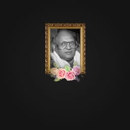 Black and white portrait of an elderly man with glasses in an ornate golden frame decorated with flowers against a black background