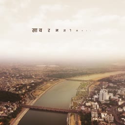 Aerial view of the Sabarmati river, riverfront, and surrounding urban city in Ahmedabad, India with hazy sky.
