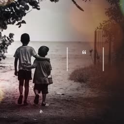 Two young boys walking together on a beach path at dusk