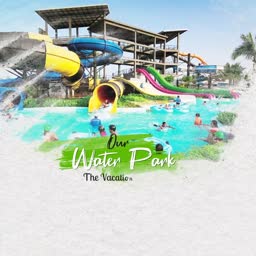 A colorful water park with twisting slides and a bright blue swimming pool filled with people