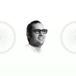 Black and white portrait of Sanjay Gandhi with Indian flag chakra symbols in the background
