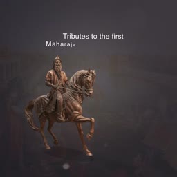 A regal bronze statue of the first Maharaja on a horse against a foggy background