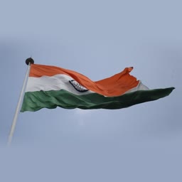 The tricolor Indian national flag waving against a cloudy sky