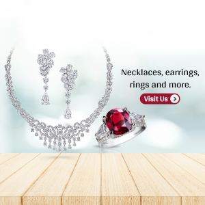A display of an intricate diamond necklace, matching earrings, and a large ruby engagement ring on a wooden table surface.