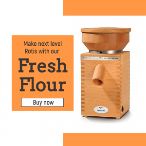 KoMo FlicFloc grain mill on orange background with text promoting fresh flour for rotis