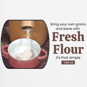 A grain mill dispensing freshly ground flour into a speckled pink bowl with promotional text nearby.
