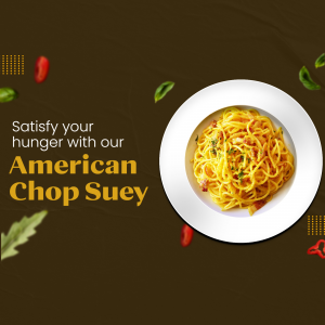 A plate of yellow American Chop Suey pasta on a dark brown background with decorative herb and spice accents.