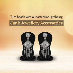 A pair of decorative silver-toned junk jewellery earrings on black stands against a warm, bokeh background.