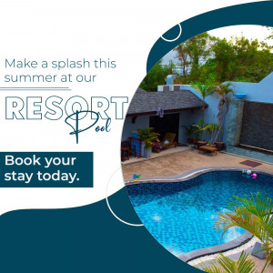 Luxury resort pool area with lounge chairs and tropical plants during summer