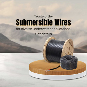 A wooden spool and coil of black submersible electrical wires placed on a wooden pedestal against a mountain landscape backdrop.