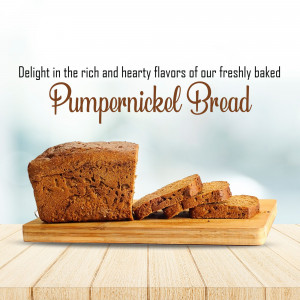 A loaf of freshly baked pumpernickel bread sliced on a wooden board