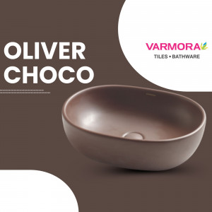 A brown oval-shaped designer wash basin from Varmora Tiles and Bathware against a dark brown background.