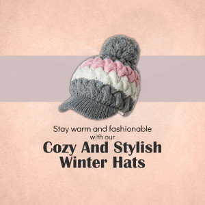 A trendy gray, white, and pink cable-knit beanie with a pom-pom and brim on a soft peach textured background.