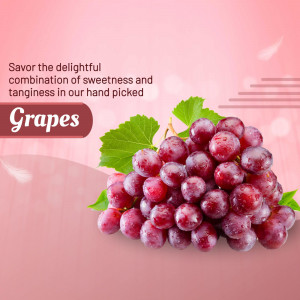 A cluster of fresh red grapes with green leaves against a soft pink background with text.