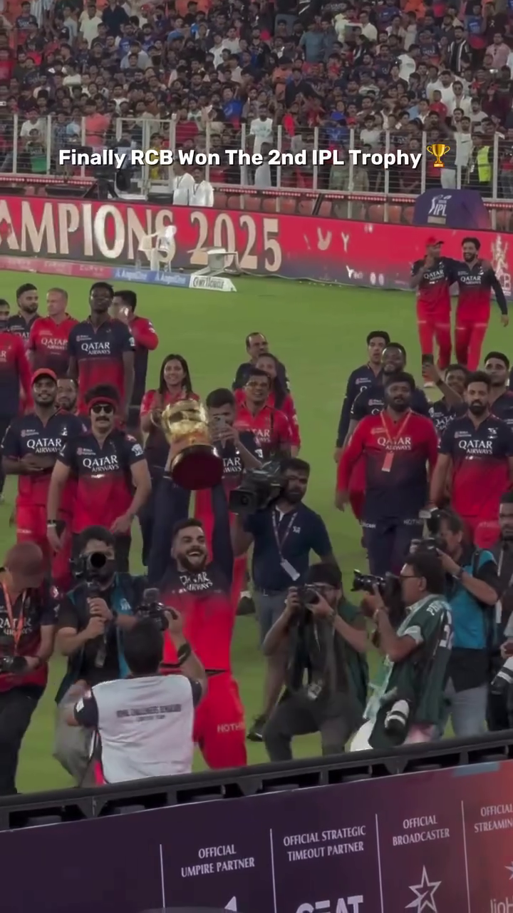 Royal Challengers Bengaluru team celebrating their IPL 2025 trophy victory on the cricket field