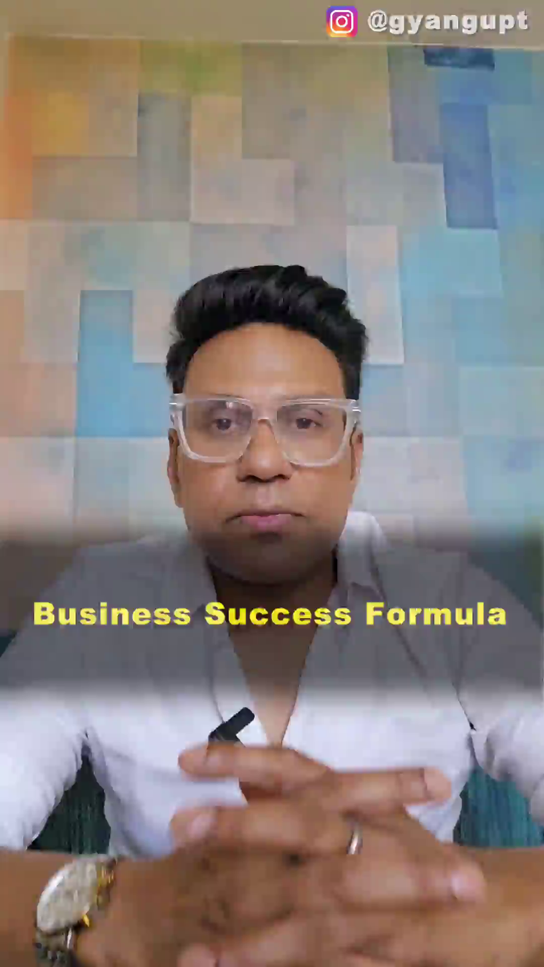A man wearing glasses speaking about business success formula