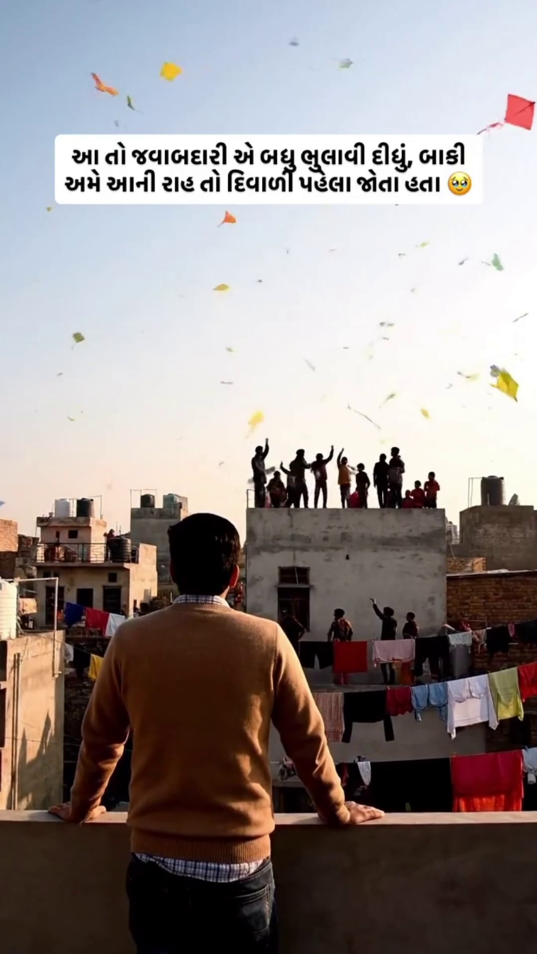 A person looking at a rooftop full of people flying kites during Makar Sankranti