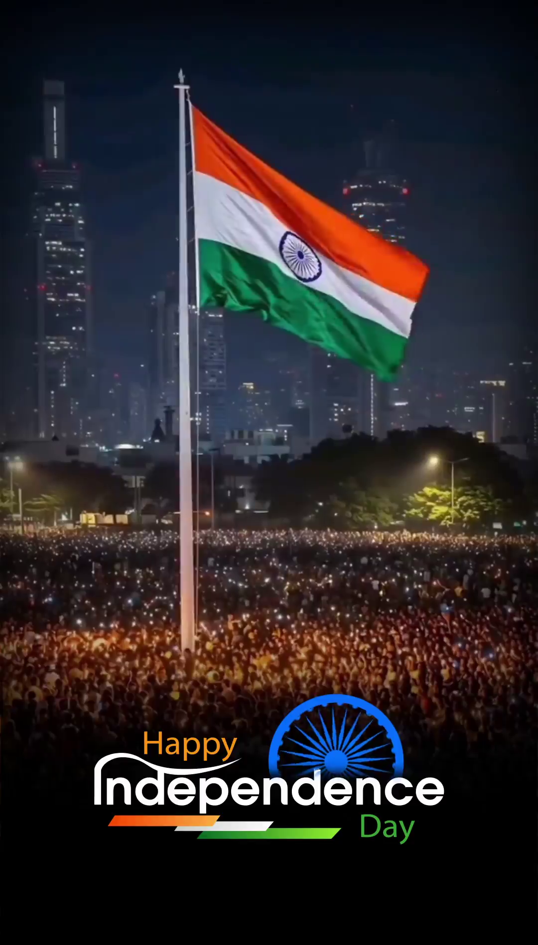 The Indian flag flying high above a large crowd celebrating Independence Day at night