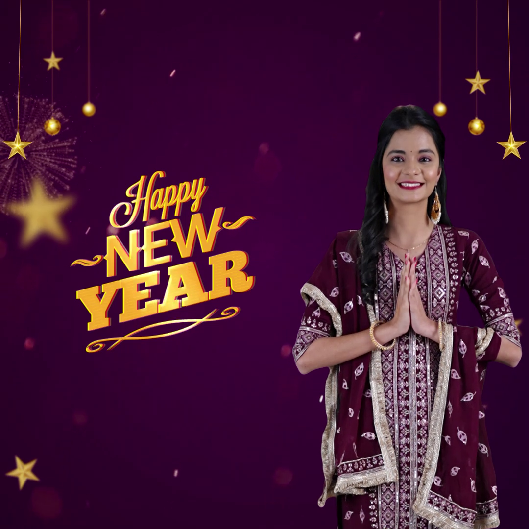An Indian woman in traditional attire greeting with folded hands against a purple Happy New Year background