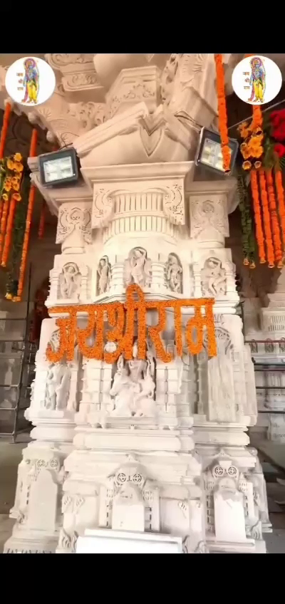 Intricately carved stone pillar decorated with marigold flowers and Jai Shri Ram text at Ram Mandir