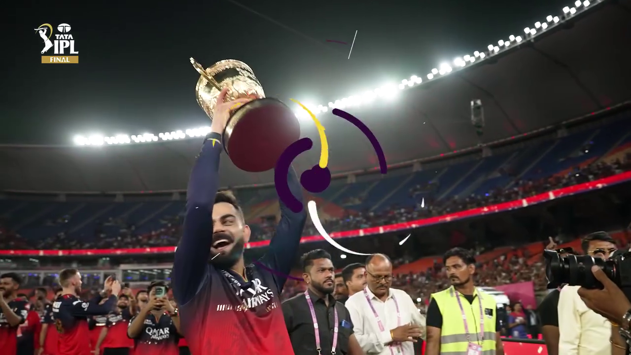 Virat Kohli celebrating with the IPL trophy in a packed cricket stadium