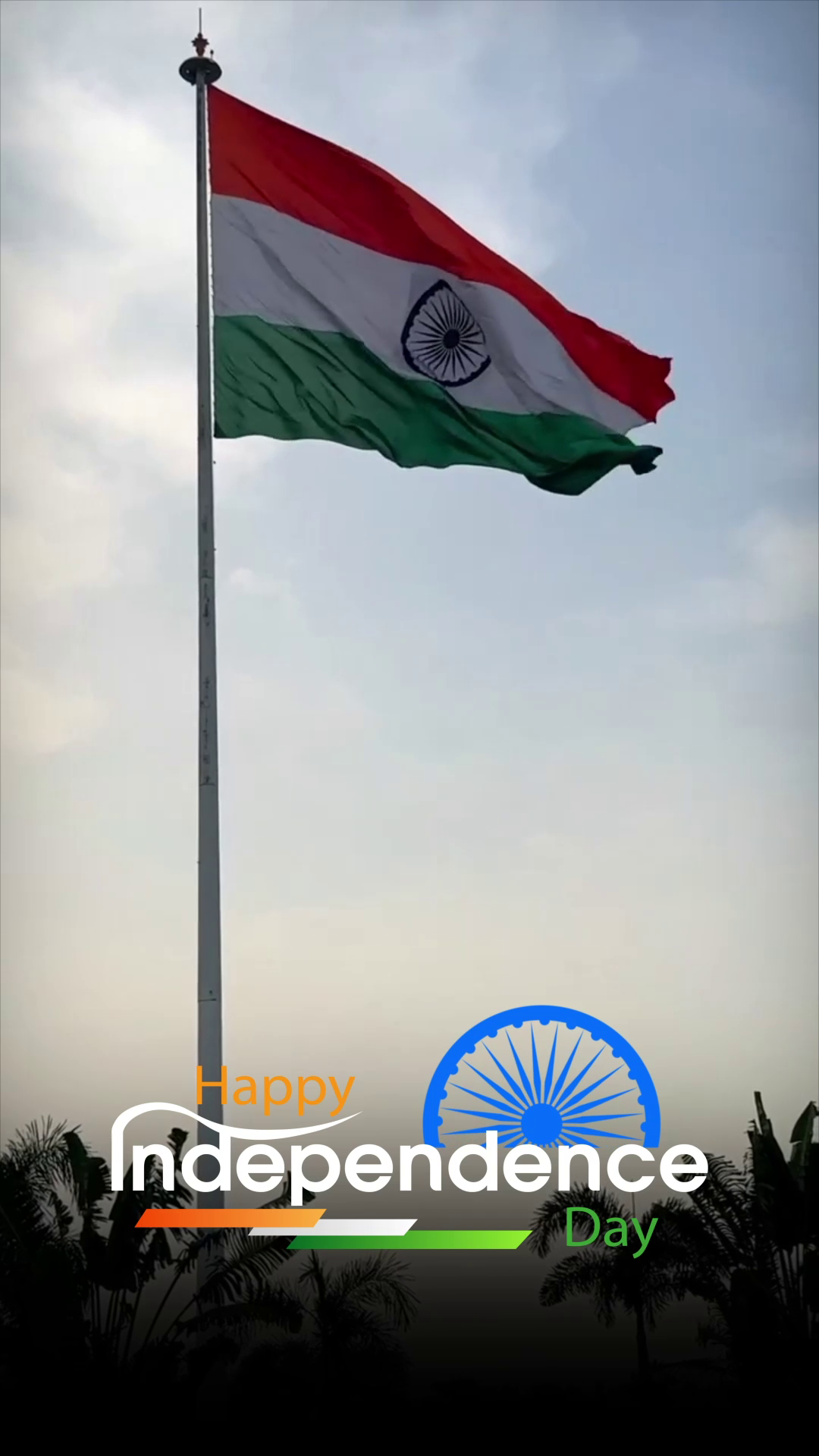 The Indian tricolor flag waving proudly on a flagpole against a cloudy sky with Independence Day greeting