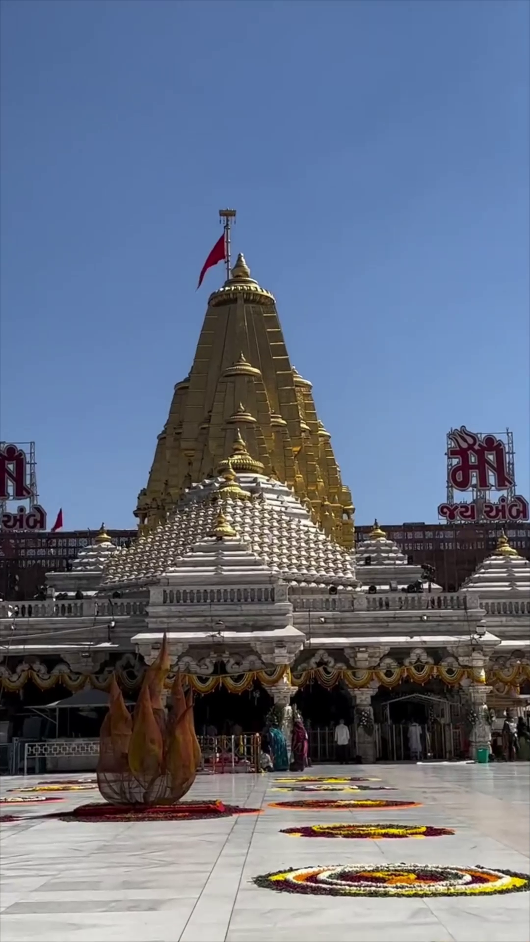 The majestic gold-topped Ambaji Temple against a clear blue sky