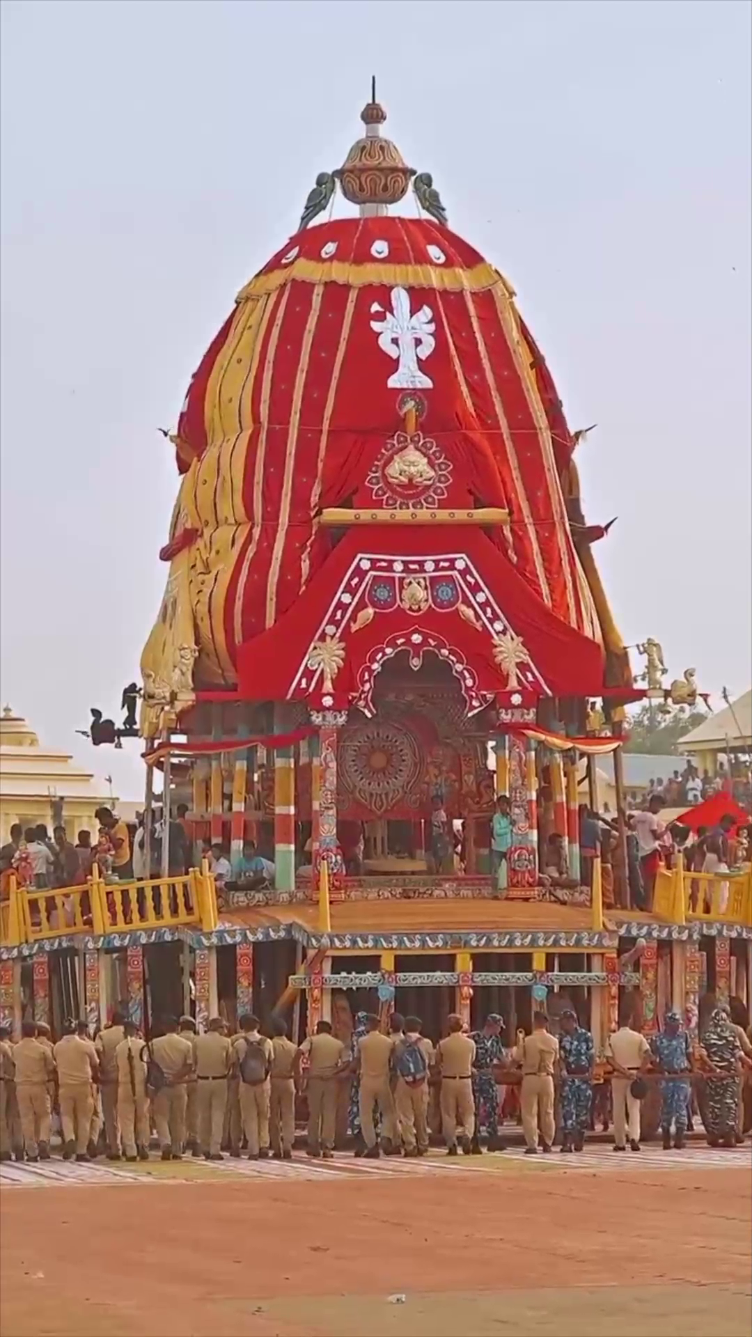 A towering, ornate red and yellow chariot of Lord Jagannath being pulled by devotees during the Rath Yatra festival.