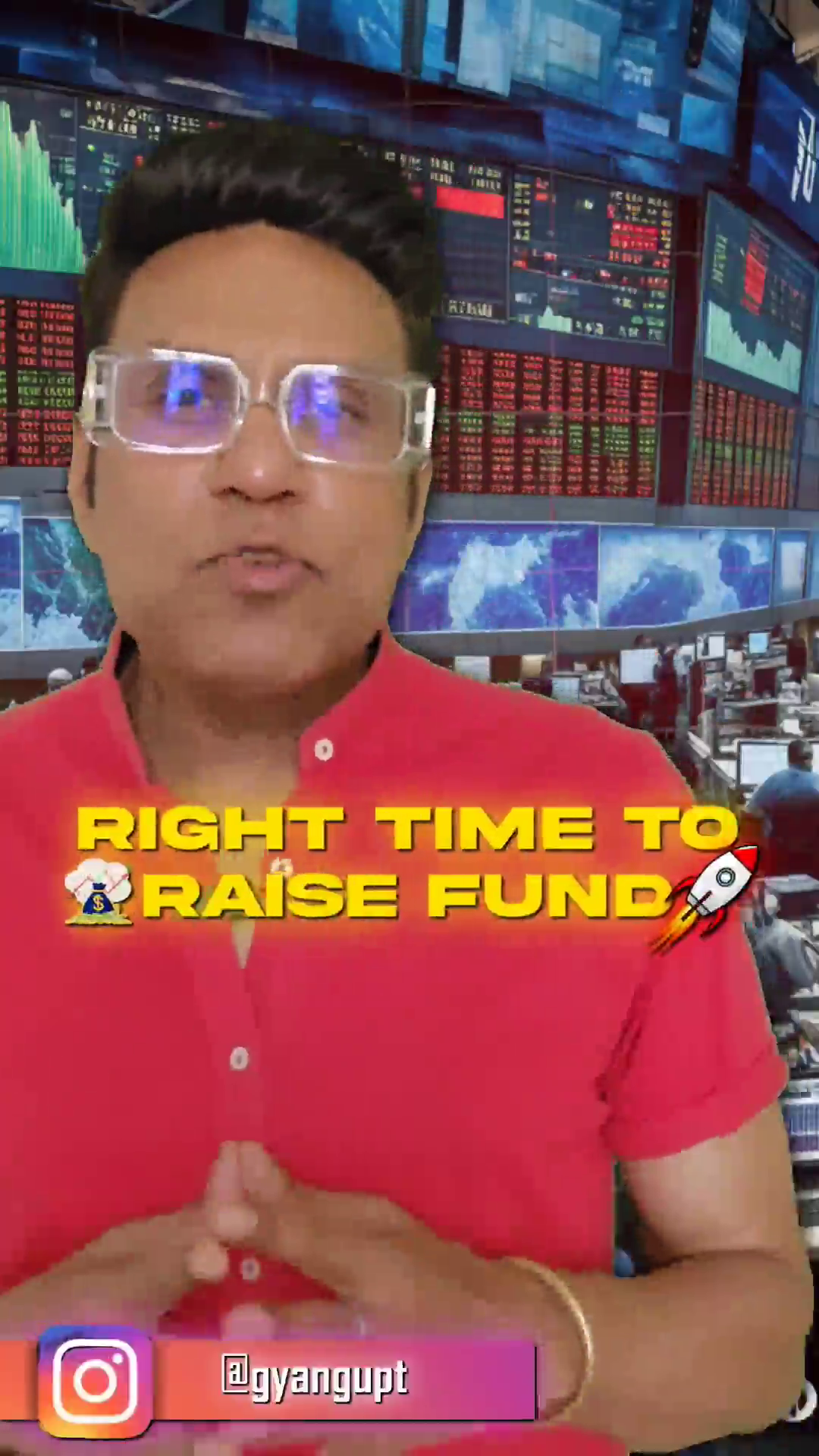 A man in a red shirt talking about raising funds in front of a stock market display