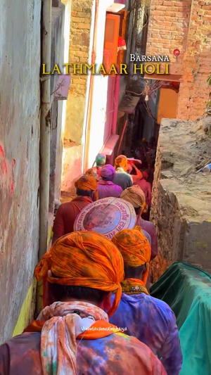 Crowd participating in the vibrant Lathmaar Holi festival in a narrow street of Barsana, India