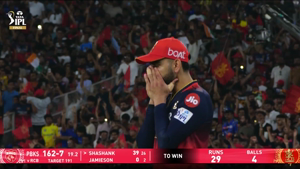 Virat Kohli in RCB jersey looking emotional during a TATA IPL cricket match with crowd in background