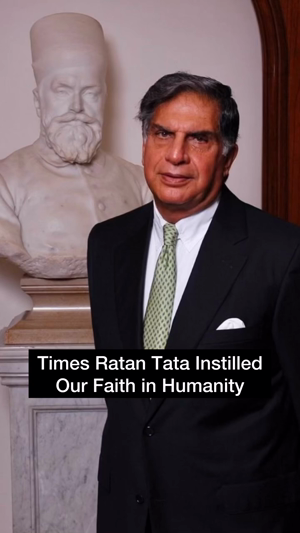 Ratan Tata standing next to a marble statue of Jamshedji Tata