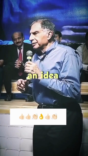 Ratan Tata speaking into a microphone on stage with text an idea overlaid