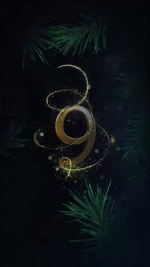 A golden number 9 surrounded by twinkling lights and pine branches against a dark background