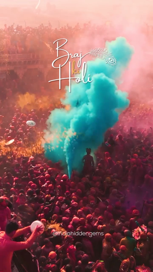 Vibrant celebration of Braj Ki Holi with colorful powder clouds amidst a dense crowd